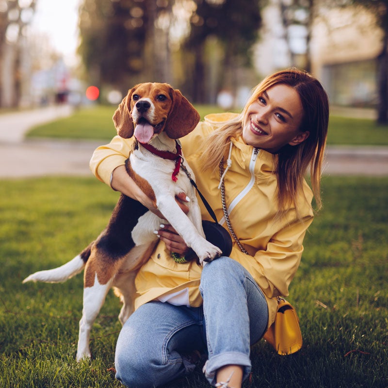 A lady holding her dog after allergy testing in Jupiter, FL