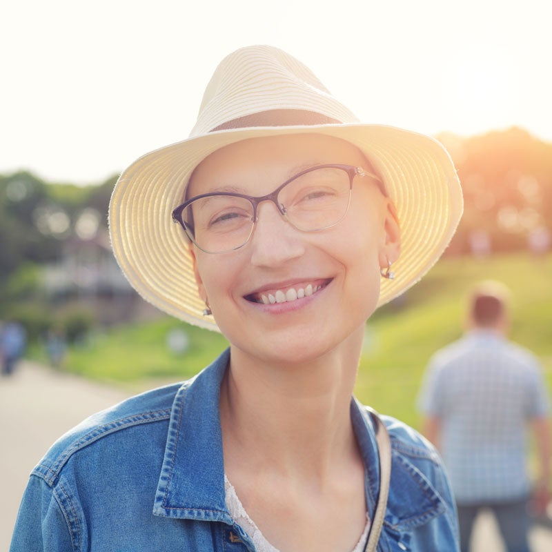 A woman smiling on a sunny day after receiving treatment for her sinus infection in Jupiter, FL.