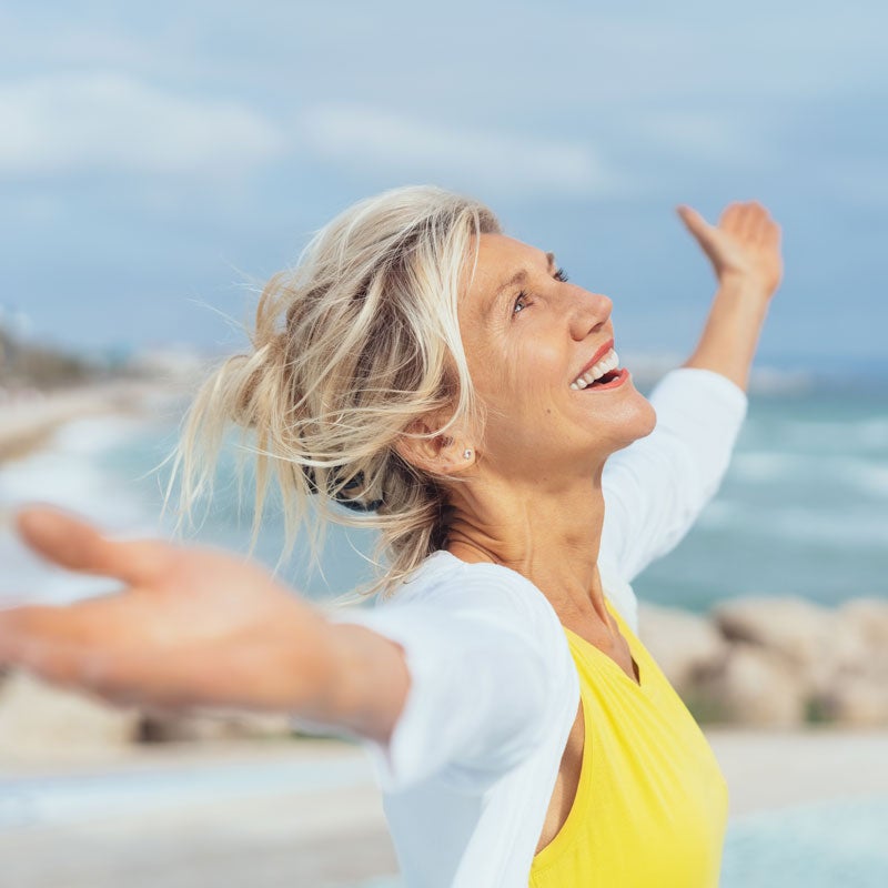 A woman enjoying on the beach after her Sinus treatment in Jupiter, FL