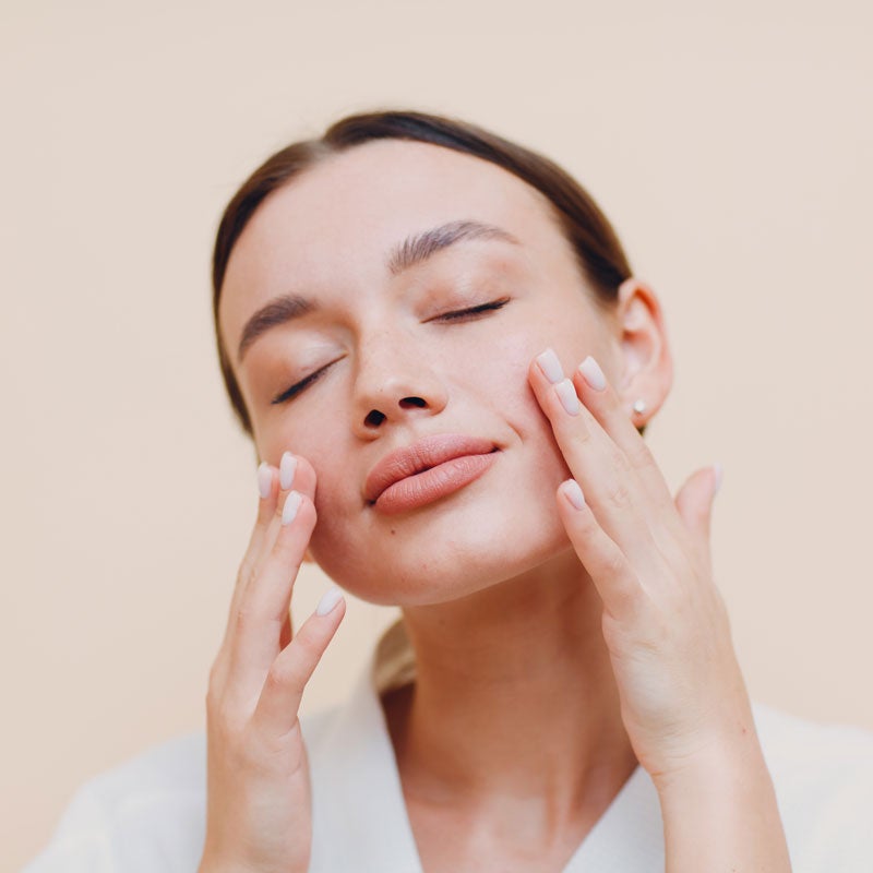 Woman feeling the face post treatment in Jupiter, FL