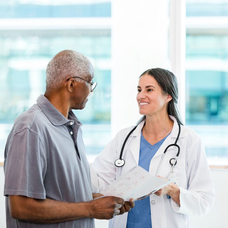 An elderly patient is talking to his doctor about his sinus infection treatments in Jupiter, FL.