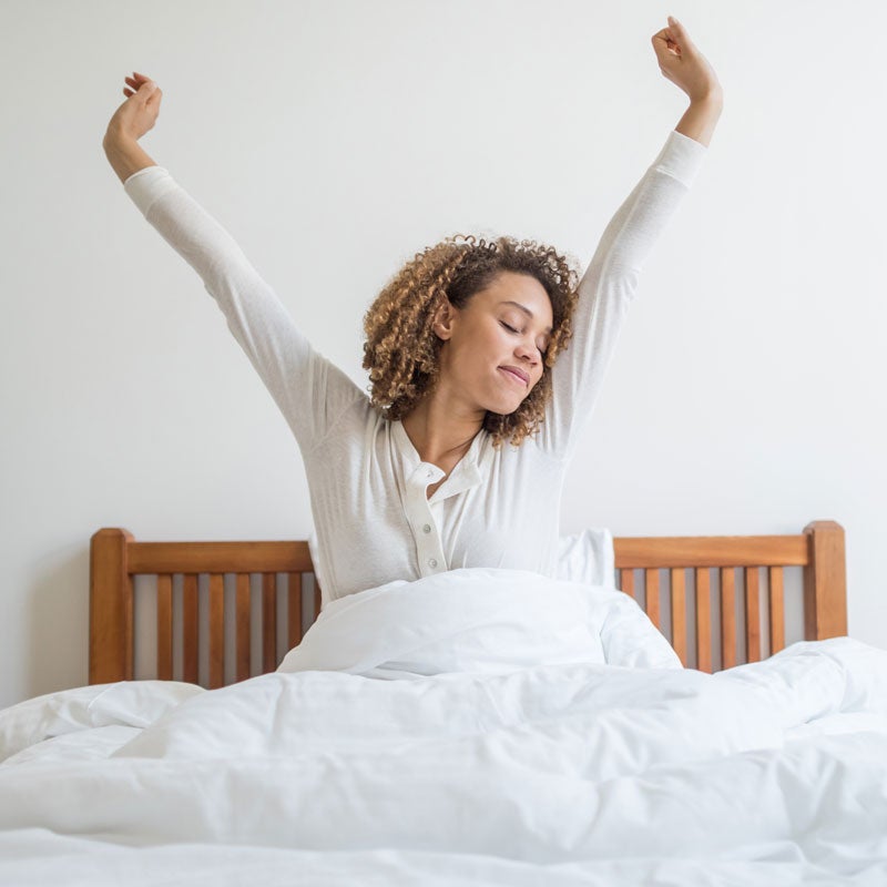 lady stretching in bed