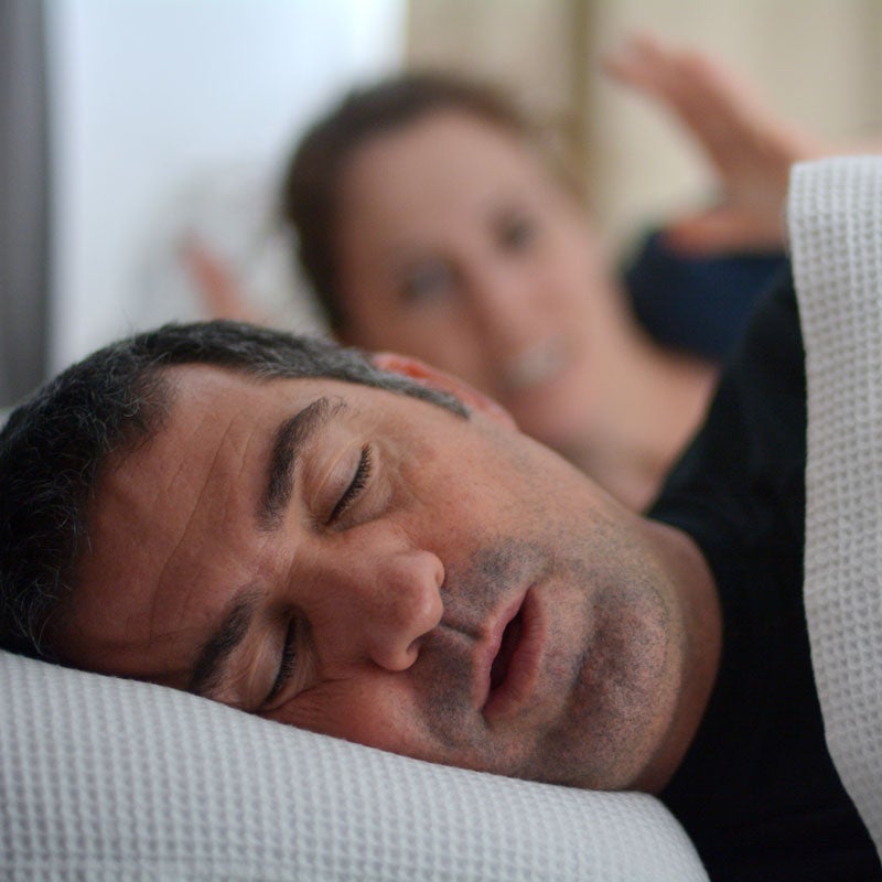 A wife feeling embarrassed by her husband's snoring due to his sinus infection in Jupiter, FL.