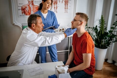 A doctor examining a patient's throat during an allergy test in Jupiter, FL.