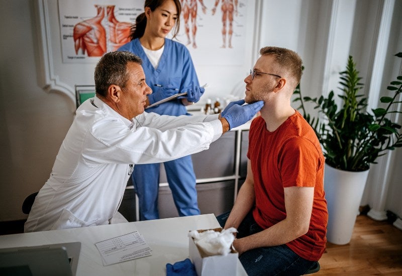 A doctor examining a patient's throat during an allergy test in Jupiter, FL.