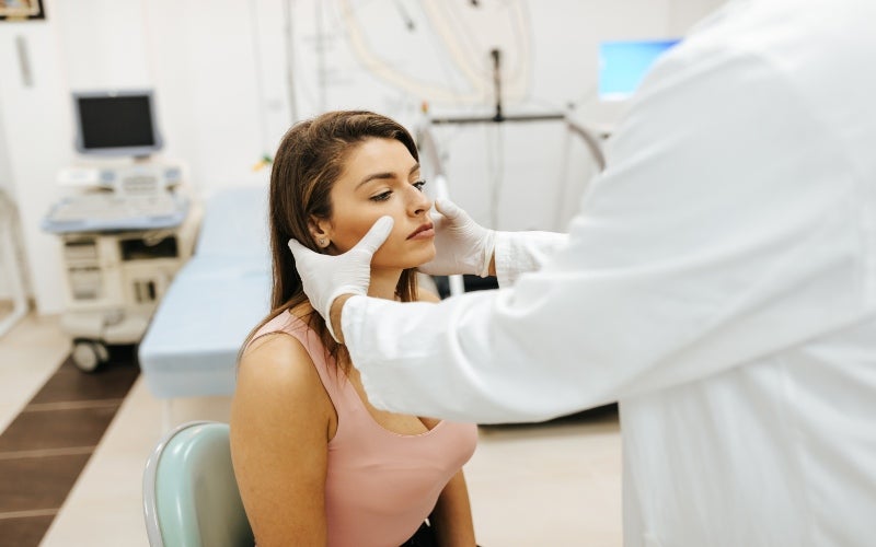 A woman consulting with a doctor about her sinus issues in Jupiter, FL.
